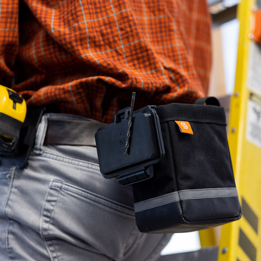 Magnetic bit box being used on a construction site.